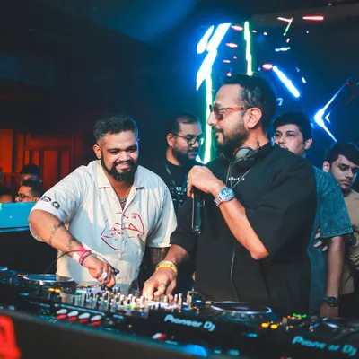 Going back-to-back with the legendary Nikhil Chinapa. In this shot, we're syncing up, sharing a laugh, and getting ready to drop the next track for an electric crowd at Opa Bar.