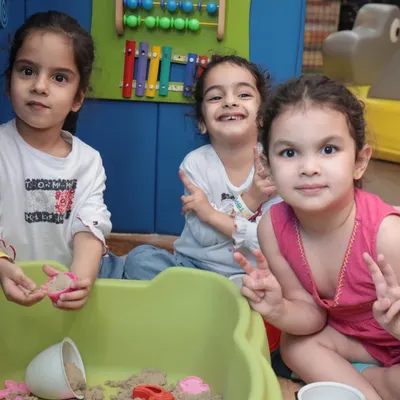 Teamwork makes the dream work! These friends are having a wonderful time in our sensory sand pit, using molds and toys to build and create together.