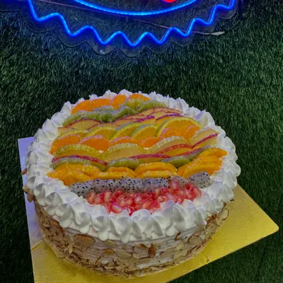 Our Mix Fruit cake is a refreshing and light option, loaded with a variety of fresh fruits like oranges, kiwi, pomegranate, and dragon fruit. The sides are coated with crunchy almonds for a perfect texture contrast.