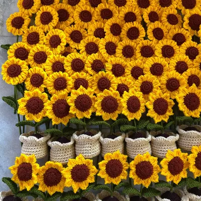 A close-up of my handmade potted sunflowers being prepared for a bulk shipment. You can see the detail in the soft, crocheted pots.