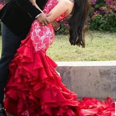 A moment of pure drama and romance. The voluminous, ruffled skirt of this custom red gown creates a stunning visual, perfect for a pre wedding photoshoot or a grand reception entrance.