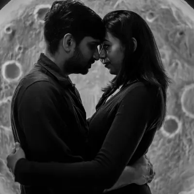 An intimate black and white silhouette of a couple in front of our moon backdrop. This artistic shot focuses on their connection, creating a timeless and romantic image.