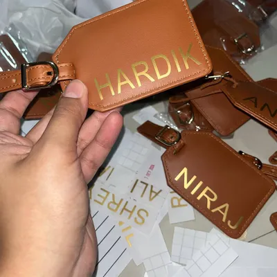 A behind-the-scenes look at personalizing leather luggage tags with gold foil for a large corporate order. Every name is applied with care.