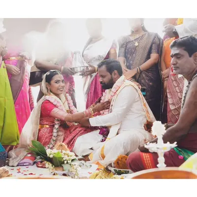 A beautiful moment during a South Indian wedding ceremony. The bride and groom are framed by family, showcasing the community and tradition that are central to the celebration.