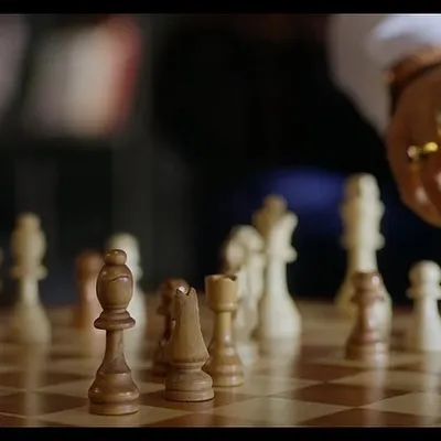 A detail shot from the Sankalp Group campaign with Ronit Roy. The focus on his hand moving a chess piece, adorned with a statement ring, adds to the character's sophisticated and strategic persona.