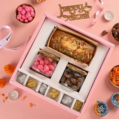 Experience the regal charm of our 'Shahi' Diwali Hamper. This royal box is filled with rose-flavored almond dragees, chocolate-coated cashews, almond rocks, and our eggless Mawa Cake.