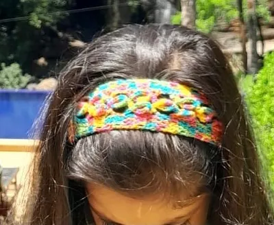 Here is one of my multi-color crochet headbands being worn. It's a comfortable and stylish way to add a pop of color to your look, perfect for any age.