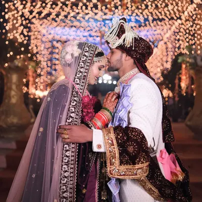 A tender moment between the couple, illuminated by a magical bokeh of lights. This is the kind of fairytale romance we love to capture on the wedding day.