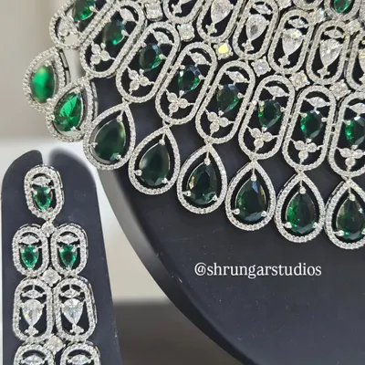 A close-up view of our silver-plated AD necklace with emerald-green teardrop stones, showing the fine craftsmanship and sparkle.