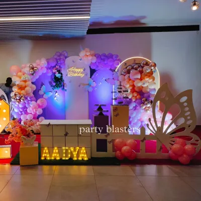 A beautiful butterfly-themed party for Aadya. This setup features a soft pastel color palette, a large butterfly wing cutout, and a neon "Happy Birthday" sign for a touch of modern elegance.