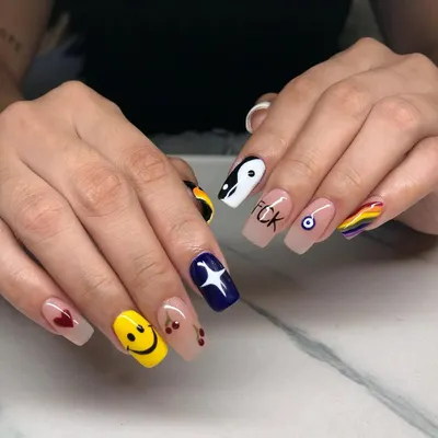 A super fun and expressive set. Each nail has a different design, including a smiley face, yin-yang, evil eye, rainbow, and cherries.