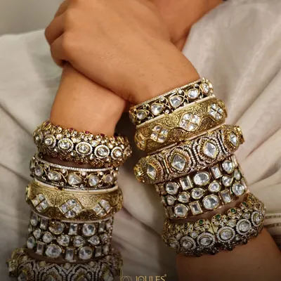 Layers of luxury for your wrist. A curated stack of wide polki and kundan kadas, showcasing different patterns and sizes for a truly opulent bridal look.