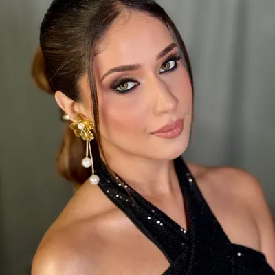 A stunning glam look perfect for a cocktail party or reception. This features a dramatic smokey eye with a pop of white liner, beautifully sculpted cheeks, and a glossy nude lip.