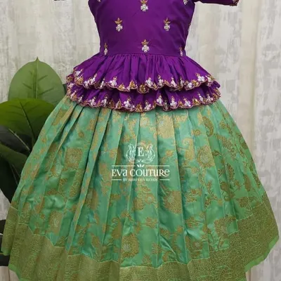 A beautiful tiered peplum lehenga in purple and sea green. The blouse is heavily embroidered, and the skirt is a rich Banarasi brocade.