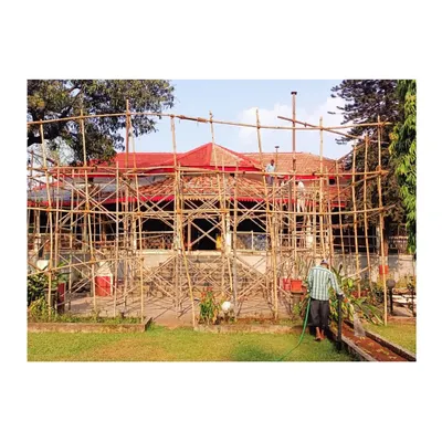 The entire edifice enveloped in scaffolding during the initial phase of restoration. This framework allows us to access and work on every part of the exterior, from the stone masonry walls to the century-old roof.