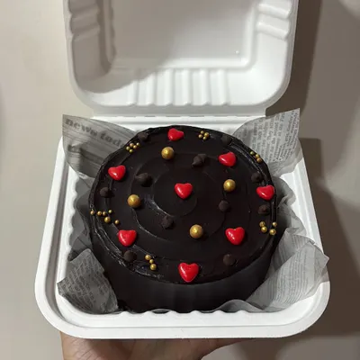 A rich, dark chocolate ganache bento cake decorated with little red hearts and gold sprinkles. A simple yet elegant way to show your love.