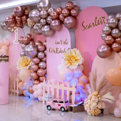 A "ONEderful" celebration for a little princess. This setup in shades of pink with metallic rose gold balloons, pampas grass, and a custom neon sign creates a glamorous and sweet first birthday party.