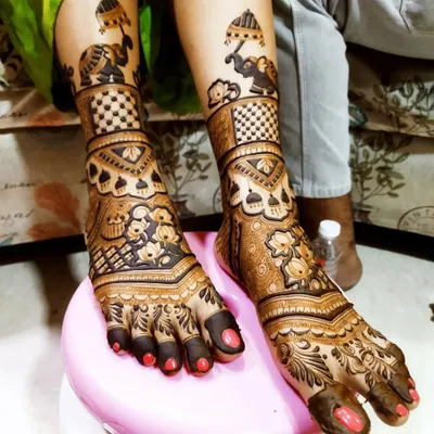 A detailed view of our bridal foot mehndi. This design features marching elephants on the ankles and rich floral and checkerboard patterns covering the feet, ensuring a stunning look.