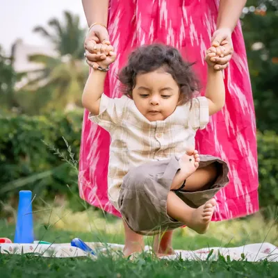 Capturing firsts is one of the most rewarding parts of my job. Here, a mother gently helps her little one take some of his first tentative steps on the soft grass. It’s a quiet, precious milestone documented forever.