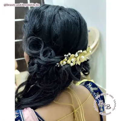 Curls are always a great choice for a reception. For this bride, I created classic side-swept curls with beautiful detailing at the back, secured with a stunning gold and pearl hair brooch for a truly bridal feel.