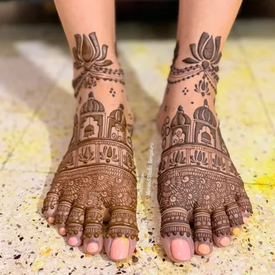 A stunningly intricate bridal foot mehendi. This design features detailed architectural domes and fine patterns covering the entire foot.