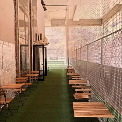 This is our Parents' Pavilion, a dedicated space with tables and chairs set up alongside the courts for you to work, watch, or relax.
