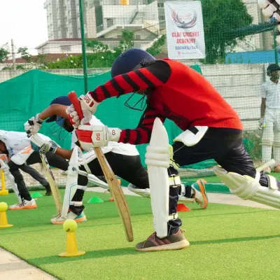 Synchronization and discipline are key. This image captures our students during a group batting drill, all practicing their forward defensive stance together, building muscle memory and technique.