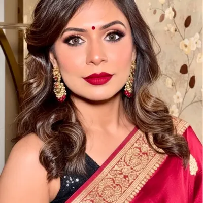 A classic festive look perfect for Navratri or any traditional celebration. I created a bold red lip and sharp winged eyeliner to complement this beautiful red and gold saree. The makeup is designed to be long-lasting for a night of dancing.