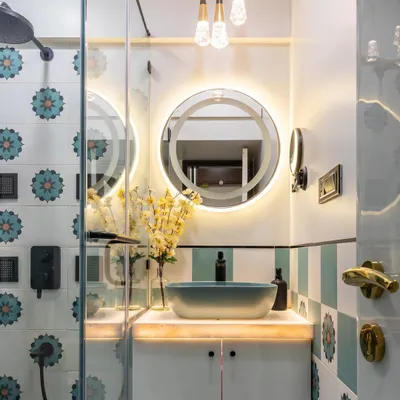 A close-up of the stunning floral-patterned tiles and backlit mirror in this bathroom. The combination of modern lighting and traditional motifs creates a unique and elevated design.