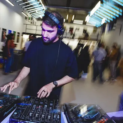 A DJ spinning at the Boxout.fm 9-year anniversary exhibition. I curate and organize events that blend music and art, providing the perfect sonic backdrop for cultural happenings.
