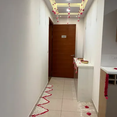 An elegant and simple housewarming decoration for a client's home. I created a pathway of flower petals and hung floral strings from the ceiling to create a warm and welcoming entrance.
