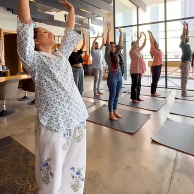 The joy on everyone's face says it all. This is a moment from a corporate yoga session where we focused on simple, uplifting stretches to release tension from the neck, shoulders, and back. You can see how accessible and enjoyable it is for the whole team.