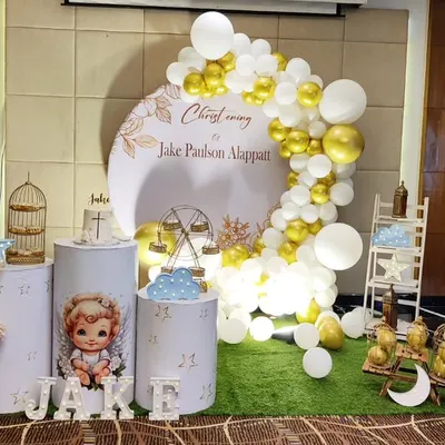 An elegant Christening celebration for baby Jake. The white and gold theme features a custom backdrop, delicate props like a birdcage and ferris wheel, and beautiful balloon columns.
