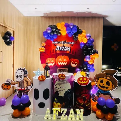 We had a blast creating this spooky and fun Halloween-themed birthday for Afzan. The decor features a jack-o'-lantern backdrop, character cutouts of a scarecrow and Jason Voorhees, and a balloon arch in classic Halloween colors of orange, purple, and black.