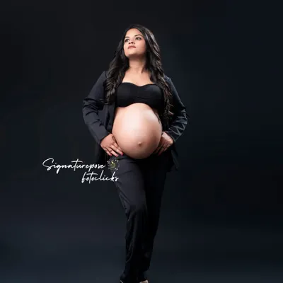 A powerful, full-length portrait in a black pantsuit. This look is all about celebrating the strength and confidence of motherhood.