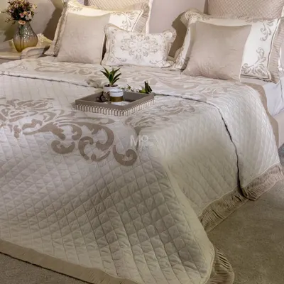 Our Magnolia-Themed Bed Cover Set, styled with a decorative tray. This view shows how the minimalistic luxury of the set, with its delicate embroidery and pleated fringes, creates a truly timeless piece.