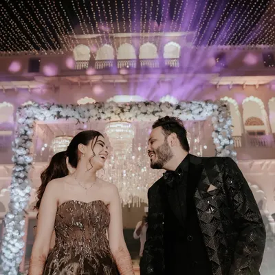 A magical Sangeet night portrait under a ceiling of fairy lights. We use the stunning decor of your event to create romantic and glamorous shots for couples like Shriya and Sanchit.