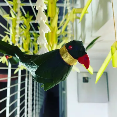 This close-up shows a handcrafted parrot made from green leaves, a traditional decorative element in South Indian events. The fine details, like the red beak and gold collar, showcase my commitment to craftsmanship.