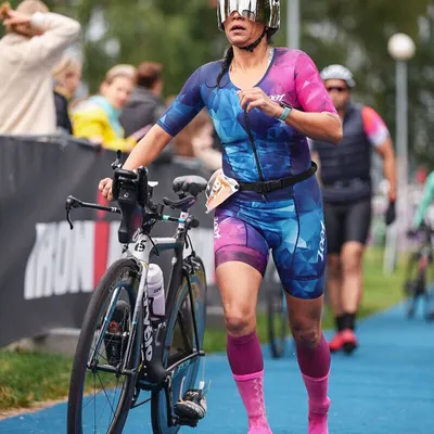 Running with my bike into transition. This is the end of the bike leg, and every second counts. Efficient transitions are a skill we practice repeatedly.