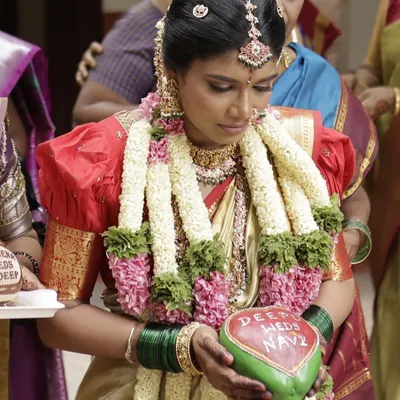 It's a joy to see our work become part of your cherished moments. Here, a beautiful bride holds a coconut we personalized for her wedding ceremony, with the couple's names hand-painted on it.