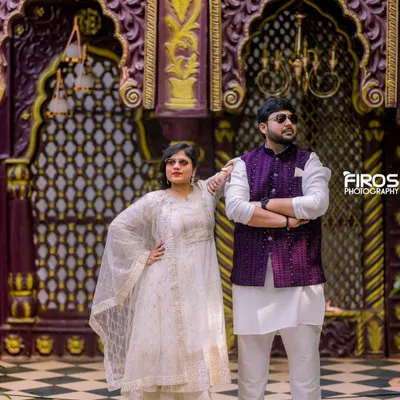 This regal backdrop with intricate purple and gold arches is part of our Jaipuri-inspired collection, perfect for adding a touch of royalty to your pre-wedding or traditional photoshoot.