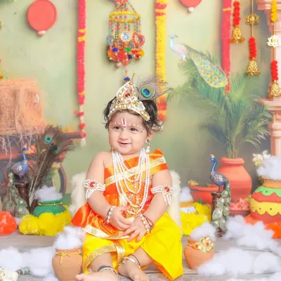 Your little Krishna, sitting on his throne. I design my sets with rich, traditional details to make these portraits feel authentic and special.