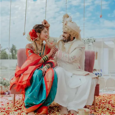 A playful moment between the bride and groom during their Maharashtrian wedding ceremony. Capturing these candid interactions is key to telling an authentic wedding story.
