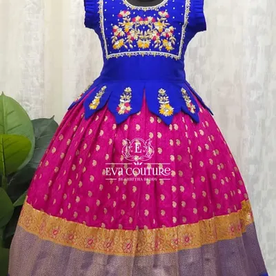 A royal combination of blue and pink. This Pattu Pavadai features a blouse with beautiful floral maggam work and a peplum waist with petal details.