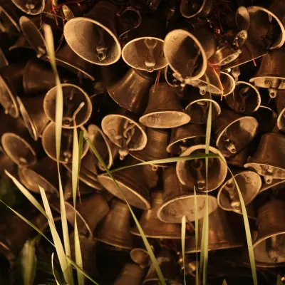 The sound of tradition. A close-up of the clusters of brass temple bells that were a key part of the Banaras Ghat mandap, adding an authentic, spiritual element to the decor.