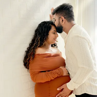 An intimate moment between expecting parents. We focus on capturing the quiet connection and affection in our couples maternity photography sessions.