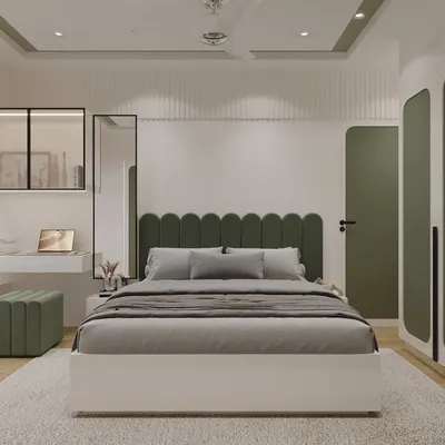 This is a full view of the olive-green bedroom, showing how all the elements come together. The scalloped headboard, matching ottoman, and custom wardrobes with rounded panels create a cohesive and calming design, complemented by a practical window seat and study nook.