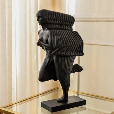 This black abstract sculpture of a running man captures the dynamic spirit of motion and progress. Its modern, fluid form makes it a powerful statement piece for a contemporary office or living room.