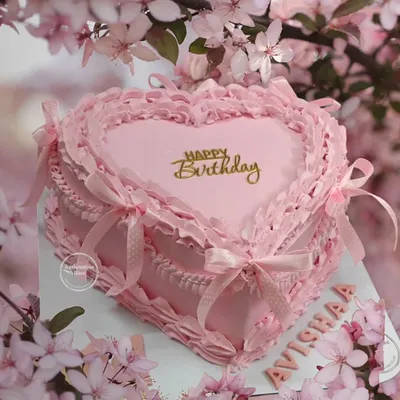 A stunning pink vintage heart cake. This design features intricate, frilly piping and delicate ribbon bows, perfectly capturing the romantic coquette aesthetic.