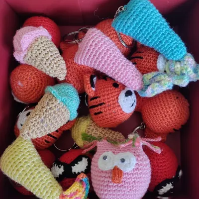 A whole box of happiness! This assortment of custom crochet keychains, including tigers, owls, and ice cream cones, is going out as return favors for a birthday party.